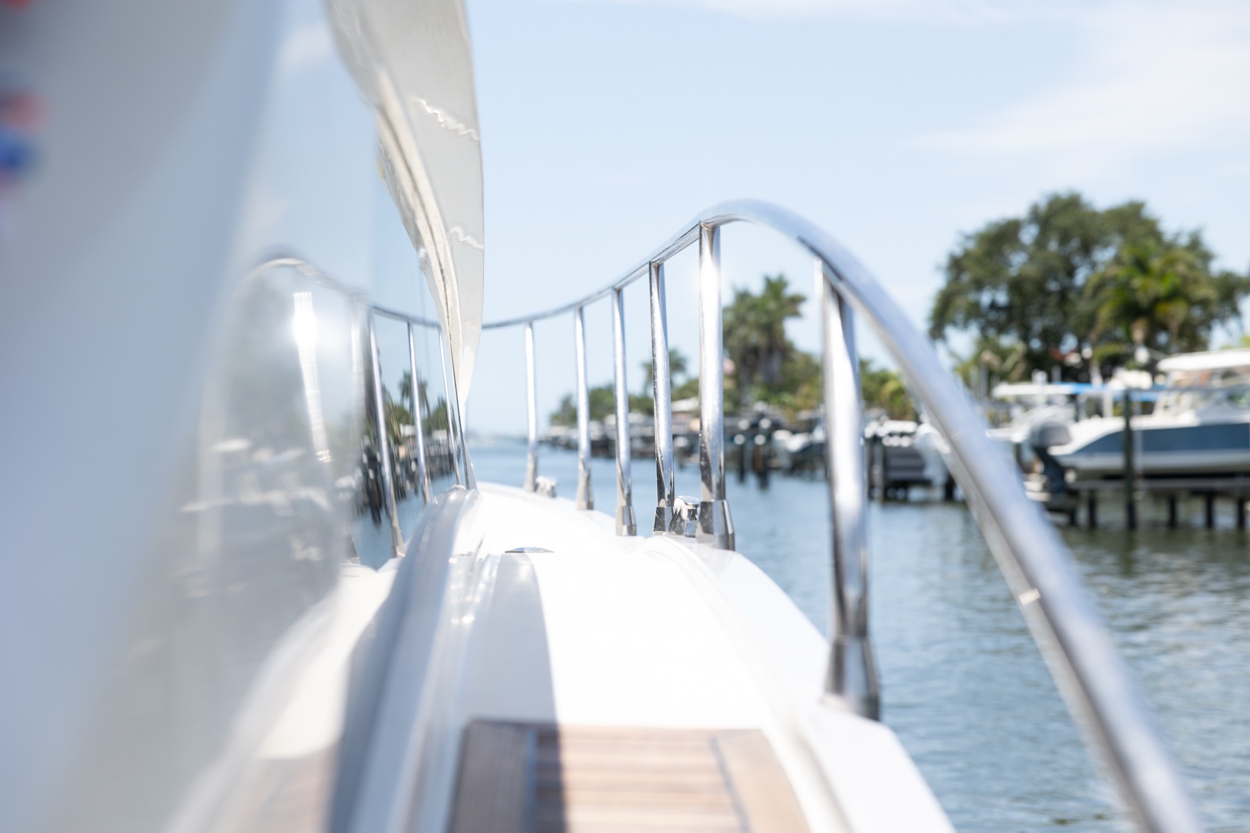 The bow rail of a charter yacht looking out over a Tampa Bay marina